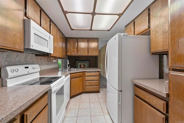 9336 Nalini Ct, Santee, CA 92071 - kitchen with white appliances, light tile patterned flooring, and brown cabinetry