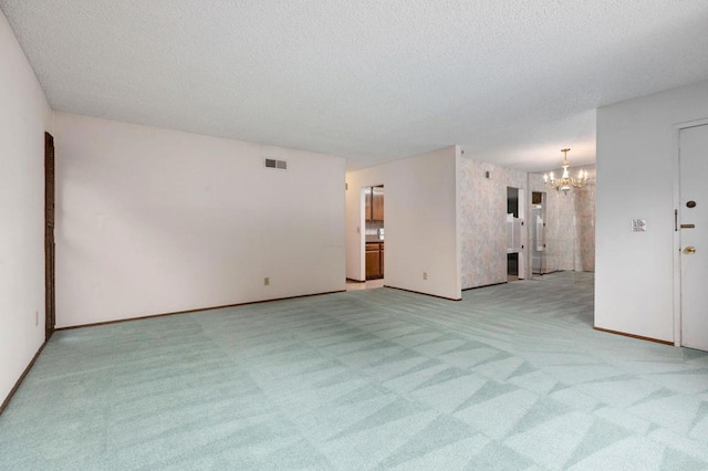 9336 Nalini Ct, Santee, CA 92071 - spare room featuring a chandelier, light colored carpet, and a textured ceiling