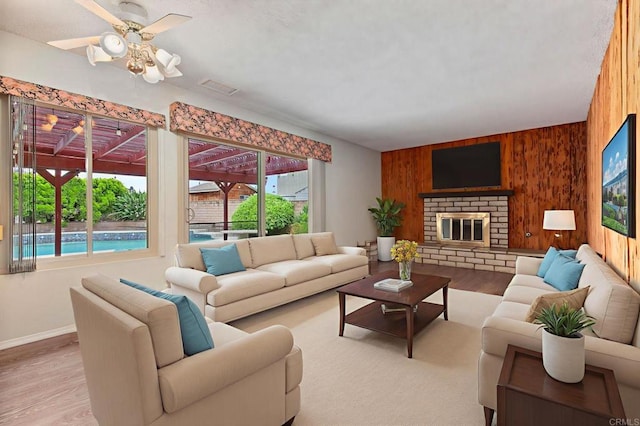 9336 Nalini Ct, Santee, CA 92071 - living area with healthy amount of natural light, wooden walls, wood finished floors, and a ceiling fan