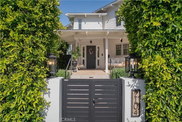 2104 Flournoy Rd, Manhattan Beach, CA 90266 - view of front of property featuring a porch, a fenced front yard, and a gate