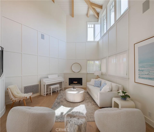 2104 Flournoy Rd, Manhattan Beach, CA 90266 - living room with a towering ceiling, healthy amount of natural light, wood finished floors, a fireplace, and wood ceiling with exposed beams
