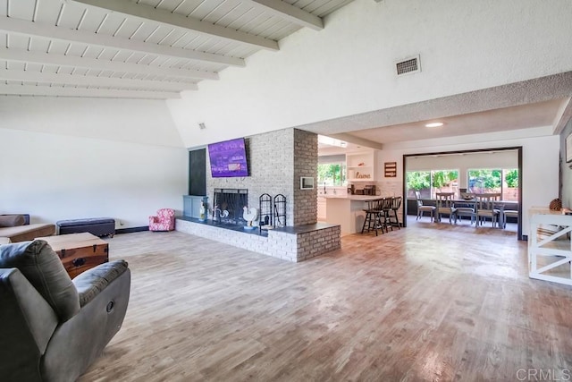 826 Terra Ln, El Cajon, CA 92019 - living area with high vaulted ceiling, wood finished floors, a fireplace, beamed ceiling, and baseboards