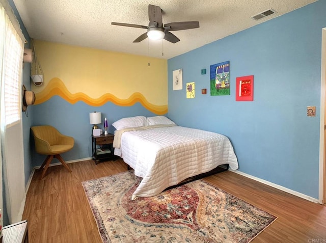1466 15th St, Imperial Beach, CA 91932 - bedroom featuring a textured ceiling, wood finished floors, baseboards, and a ceiling fan