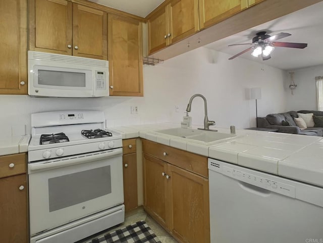 1466 15th St, Imperial Beach, CA 91932 - kitchen with white appliances, a sink, brown cabinetry, ceiling fan, and open floor plan