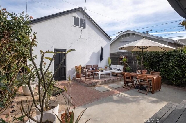 3440 Lemon Ave, Long Beach, CA 90807 - back of property featuring a patio, an outdoor hangout area, stucco siding, and outdoor dining space
