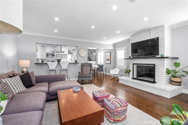 3440 Lemon Ave, Long Beach, CA 90807 - living area featuring ornamental molding, wood finished floors, recessed lighting, a fireplace, and baseboards