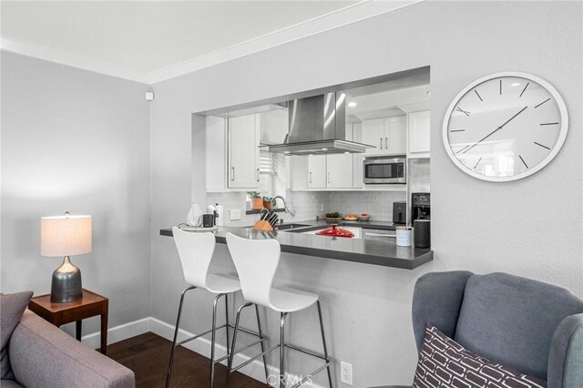 3440 Lemon Ave, Long Beach, CA 90807 - kitchen with ventilation hood, stainless steel microwave, decorative backsplash, white cabinets, and ornamental molding