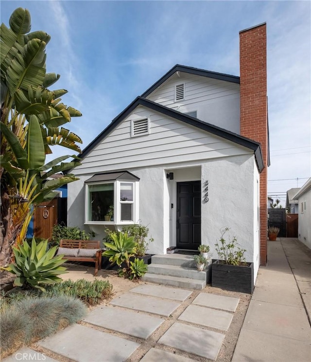 3440 Lemon Ave, Long Beach, CA 90807 - view of front of home featuring stucco siding and a chimney