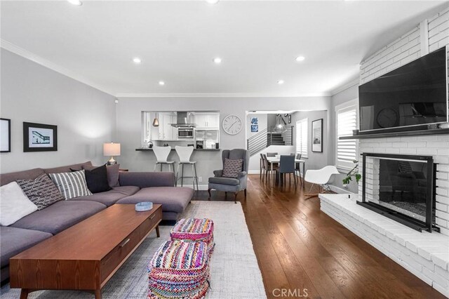 3440 Lemon Ave, Long Beach, CA 90807 - living room with crown molding, hardwood / wood-style flooring, a brick fireplace, and recessed lighting