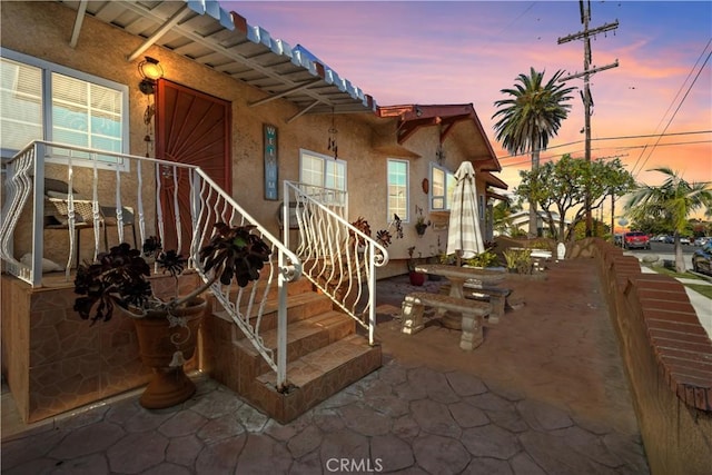 203 N Mesa St, San Pedro, CA 90731 - exterior entry at dusk featuring stucco siding and a patio