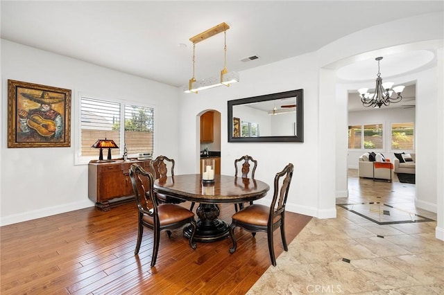 44774 Pride Mountain St, Temecula, CA 92592 - dining area featuring arched walkways, baseboards, a chandelier, and plenty of natural light