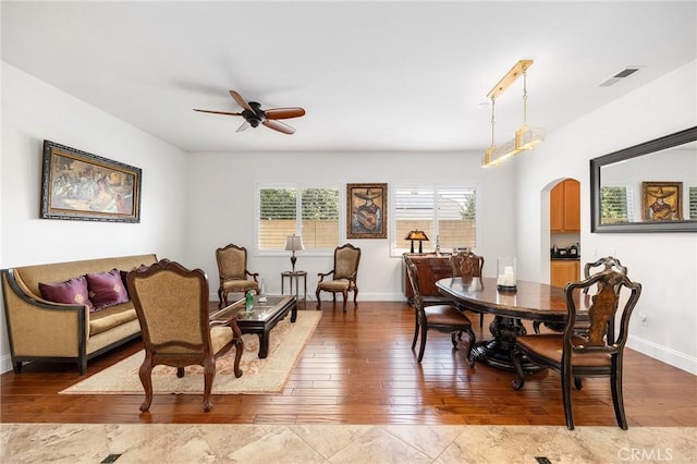 44774 Pride Mountain St, Temecula, CA 92592 - dining room featuring arched walkways, a ceiling fan, hardwood / wood-style flooring, and baseboards