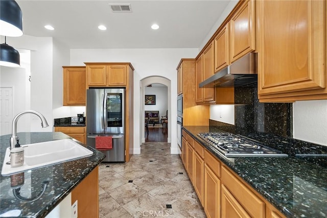 44774 Pride Mountain St, Temecula, CA 92592 - kitchen with appliances with stainless steel finishes, a sink, arched walkways, under cabinet range hood, and backsplash