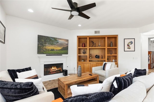 44774 Pride Mountain St, Temecula, CA 92592 - living area with a glass covered fireplace, a ceiling fan, and recessed lighting