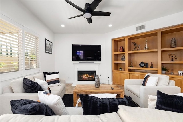 44774 Pride Mountain St, Temecula, CA 92592 - living area with a warm lit fireplace, a ceiling fan, and recessed lighting