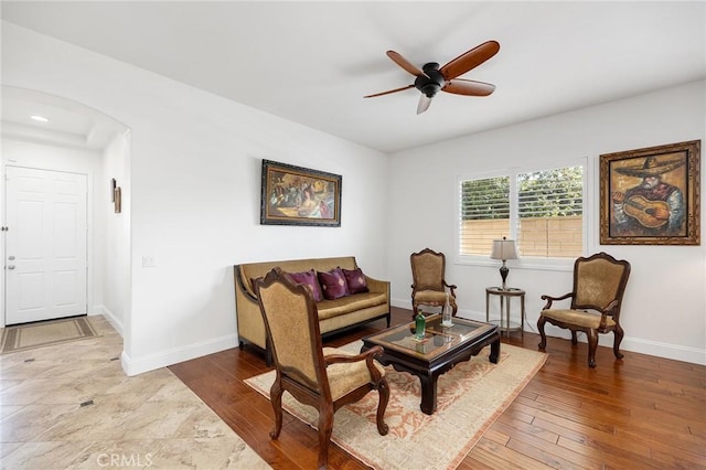 44774 Pride Mountain St, Temecula, CA 92592 - living area featuring arched walkways, ceiling fan, baseboards, and hardwood / wood-style floors