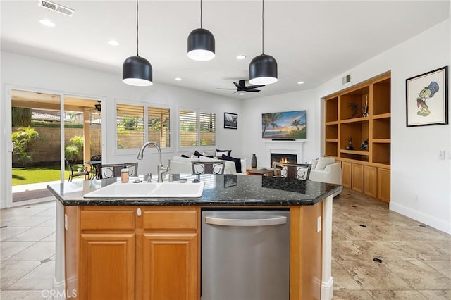 44774 Pride Mountain St, Temecula, CA 92592 - kitchen featuring dishwasher, a sink, a warm lit fireplace, ceiling fan, and an island with sink