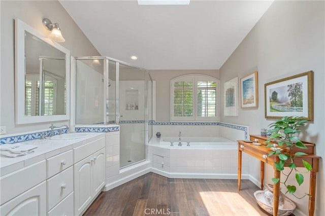 3818 Hayvenhurst Ave, Encino, CA 91436 - full bath featuring wood finished floors, vanity, a garden tub, and a stall shower
