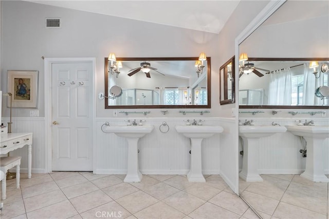 3818 Hayvenhurst Ave, Encino, CA 91436 - full bathroom featuring a ceiling fan, two sinks, healthy amount of natural light, a wainscoted wall, and lofted ceiling