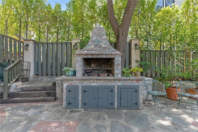 3818 Hayvenhurst Ave, Encino, CA 91436 - view of patio featuring an outdoor stone fireplace