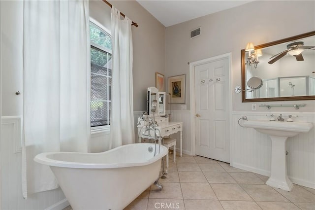 3818 Hayvenhurst Ave, Encino, CA 91436 - full bathroom with wainscoting, a freestanding tub, tile patterned floors, ceiling fan, and a decorative wall