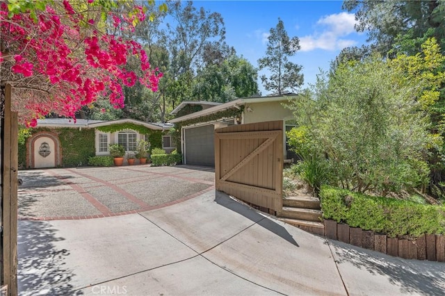 3818 Hayvenhurst Ave, Encino, CA 91436 - view of front of home featuring a garage, concrete driveway, and a gate