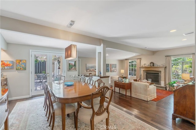 3818 Hayvenhurst Ave, Encino, CA 91436 - dining space featuring wood finished floors, french doors, a glass covered fireplace, and recessed lighting