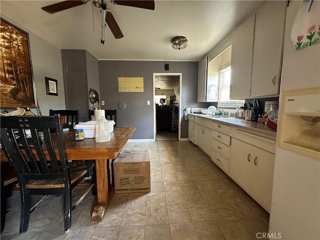 828 W 23rd St, Merced, CA 95340 - kitchen with a ceiling fan, light countertops, a sink, and baseboards