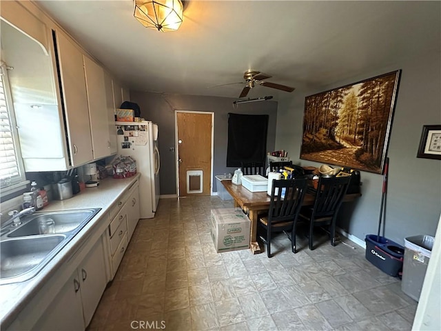 828 W 23rd St, Merced, CA 95340 - kitchen with a sink, light countertops, a ceiling fan, freestanding refrigerator, and an office area