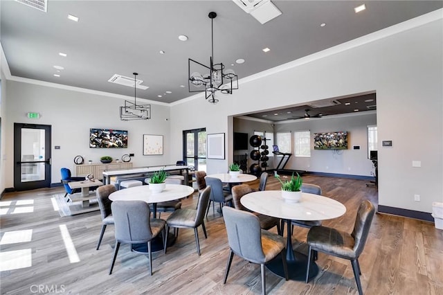 656 Daniel Freeman Cir, Inglewood, CA 90301 - dining room featuring crown molding, light wood-style flooring, baseboards, recessed lighting, and a chandelier