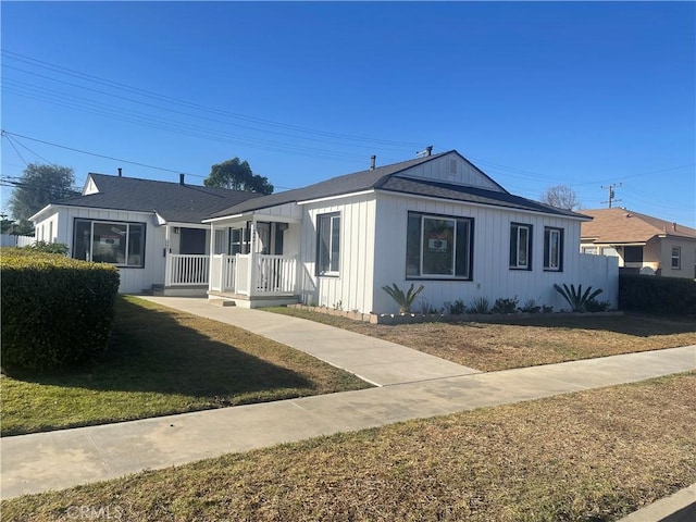 2221 Granada Ave, Long Beach, CA 90815 - view of front of house featuring a front lawn and board and batten siding