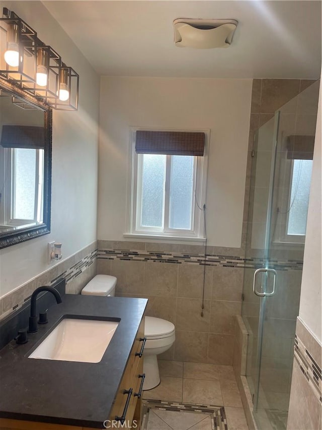2221 Granada Ave, Long Beach, CA 90815 - full bath featuring tile walls, vanity, toilet, tile patterned flooring, and a shower stall