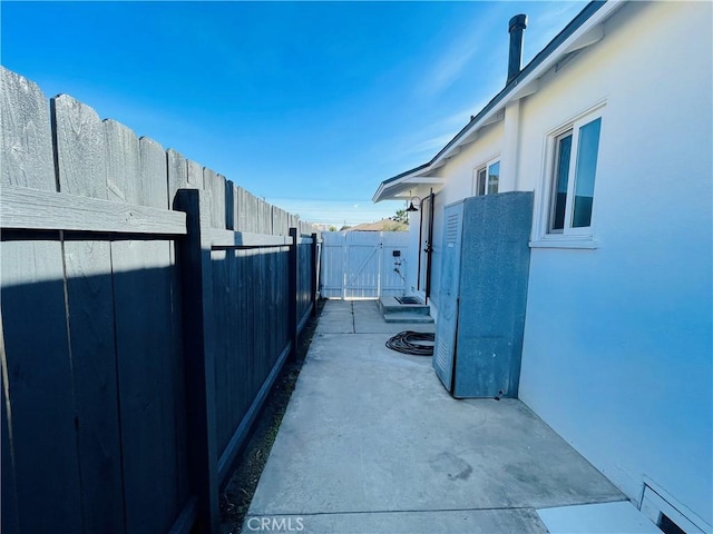 2221 Granada Ave, Long Beach, CA 90815 - view of side of property featuring a patio, a gate, and stucco siding