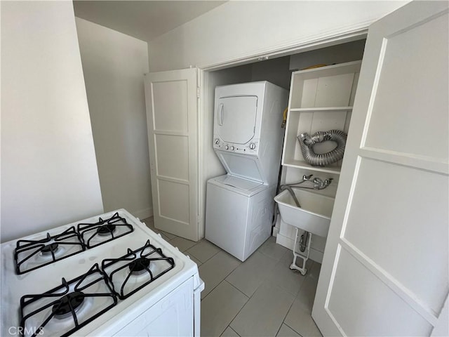 2221 Granada Ave, Long Beach, CA 90815 - laundry area featuring stacked washing machine and dryer and light tile patterned floors