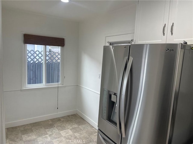 2221 Granada Ave, Long Beach, CA 90815 - kitchen with stainless steel fridge, white cabinets, and baseboards