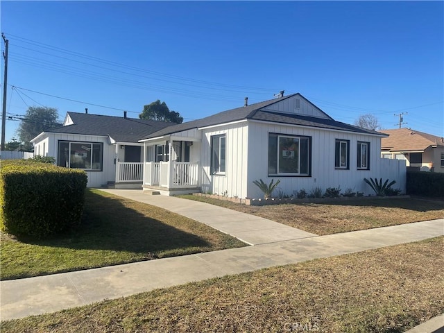 2221 Granada Ave, Long Beach, CA 90815 - view of front of home with a front lawn, covered porch, and board and batten siding