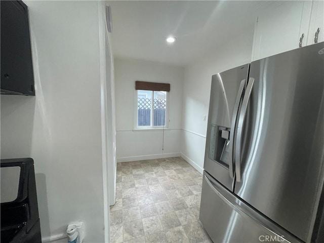 2221 Granada Ave, Long Beach, CA 90815 - kitchen with stainless steel fridge, white cabinets, recessed lighting, and baseboards