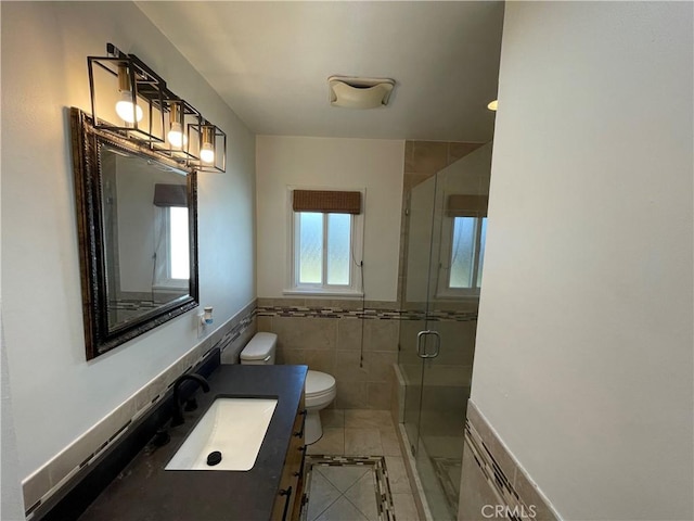 2221 Granada Ave, Long Beach, CA 90815 - bathroom featuring toilet, tile walls, a stall shower, vanity, and wainscoting