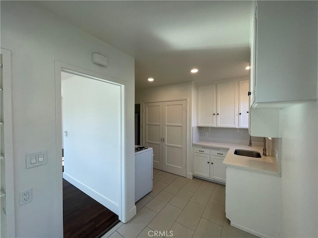 2221 Granada Ave, Long Beach, CA 90815 - kitchen with gas range, white cabinets, a sink, light countertops, and recessed lighting