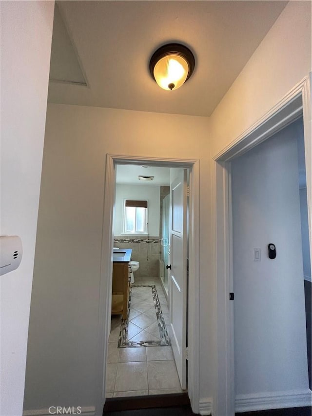 2221 Granada Ave, Long Beach, CA 90815 - hall featuring inlaid floor details, light tile patterned floors, and baseboards