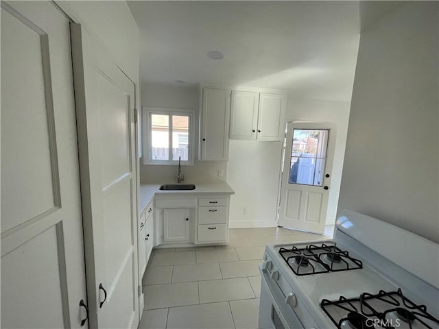2221 Granada Ave, Long Beach, CA 90815 - kitchen featuring white range with gas cooktop, a sink, light tile patterned floors, white cabinetry, and light countertops