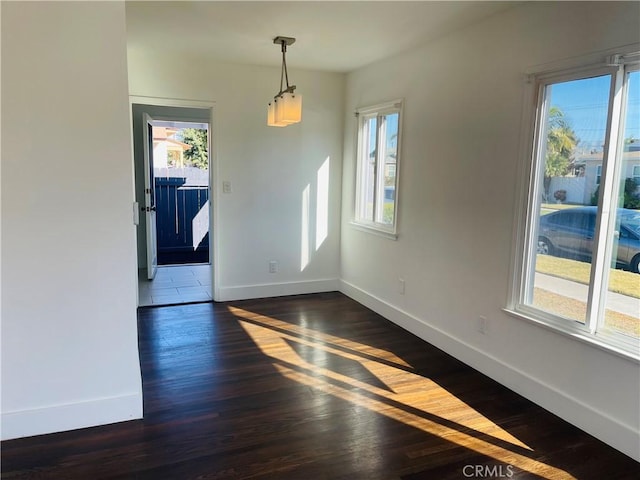 2221 Granada Ave, Long Beach, CA 90815 - unfurnished dining area with plenty of natural light, baseboards, and dark wood-type flooring
