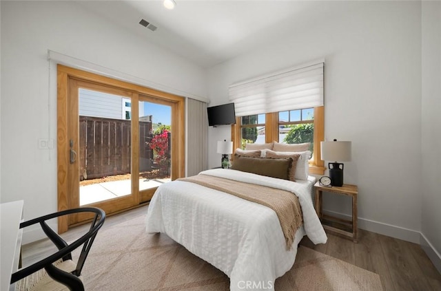313 Myrtle Dr, Arroyo Grande, CA 93420 - bedroom with wood finished floors, baseboards, and access to exterior
