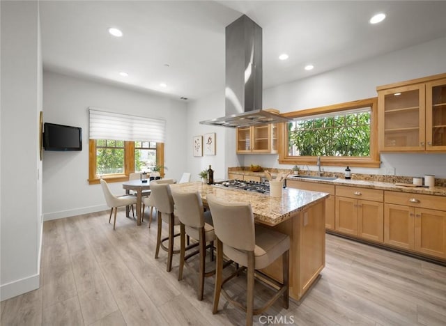 313 Myrtle Dr, Arroyo Grande, CA 93420 - kitchen featuring island range hood, a sink, stainless steel gas cooktop, light stone countertops, and a center island