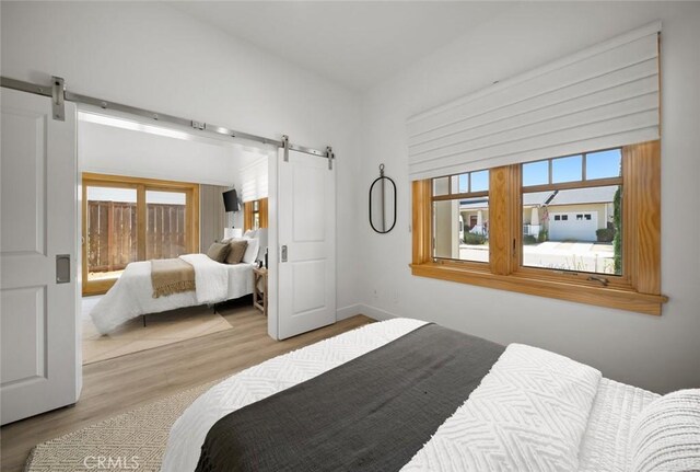 313 Myrtle Dr, Arroyo Grande, CA 93420 - bedroom featuring a barn door and wood finished floors