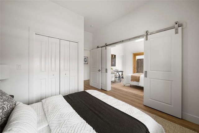 313 Myrtle Dr, Arroyo Grande, CA 93420 - bedroom with a barn door, wood finished floors, and a closet