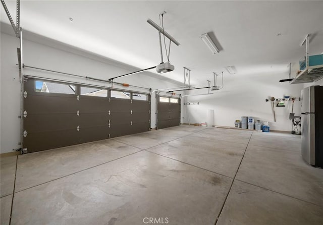 313 Myrtle Dr, Arroyo Grande, CA 93420 - garage featuring freestanding refrigerator and a garage door opener