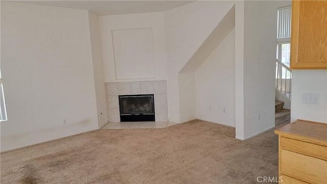 241 Exeter Way, Corona, CA 92882 - unfurnished living room with carpet, a tiled fireplace, and stairway