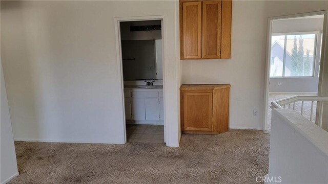 241 Exeter Way, Corona, CA 92882 - unfurnished bedroom featuring carpet floors, a sink, and baseboards