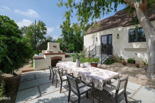 2384 E Orange Grove Blvd, Pasadena, CA 91104 - view of patio with outdoor dining space and an outdoor brick fireplace